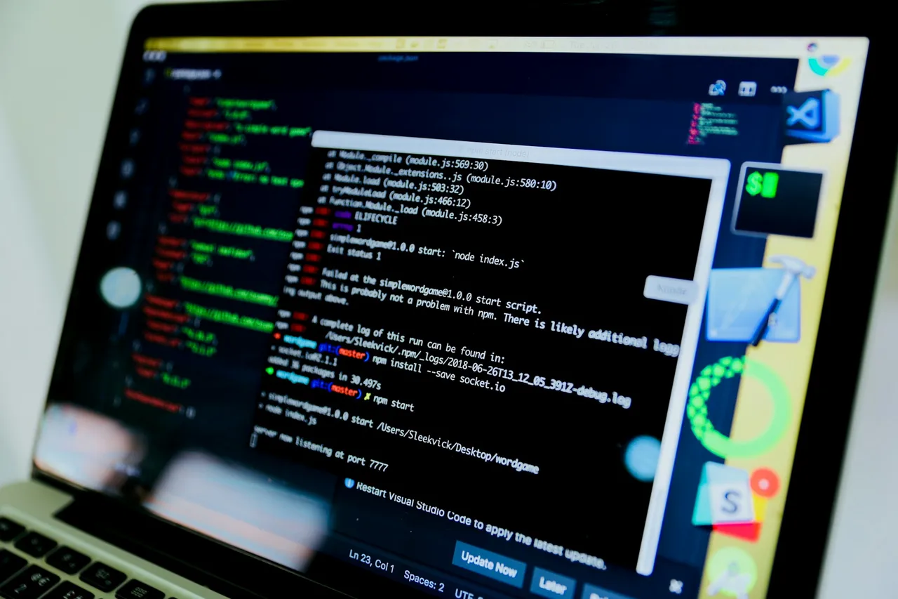 A laptop screen with a terminal window full of program messages, next to a code editor window