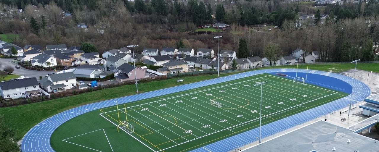 An American football field seen from above, with the yard line numbers painted on it