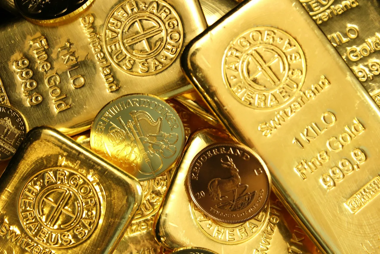 Gold bars stamped 1 KILO Fine Gold 999,9 next to gold coins including a Krugerrand